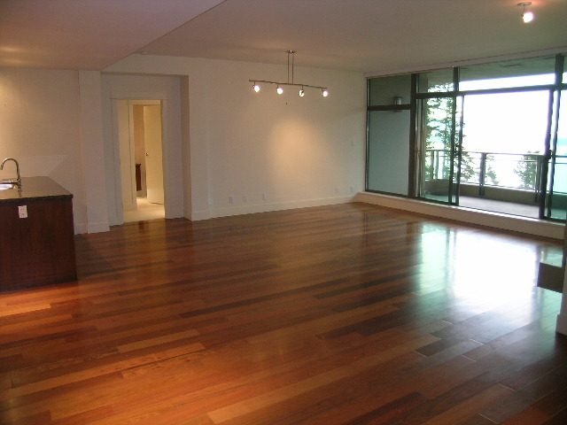 Bright living room with hardwood floors and a city view. - 602 - 3355 Cypress Place, West Vancouver