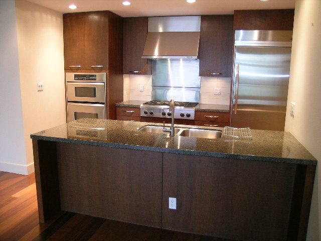 Bright kitchen with granite countertops, stainless steel appliances, and hardwood floors. - 602 - 3355 Cypress Place, West Vancouver