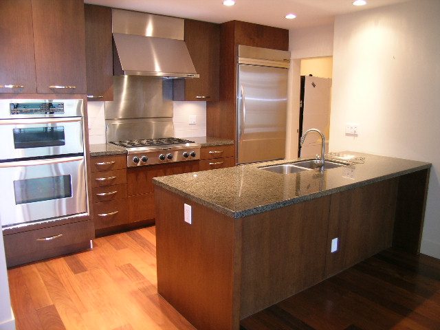 Bright kitchen with granite countertops, stainless steel appliances, and hardwood floors. - 602 - 3355 Cypress Place, West Vancouver