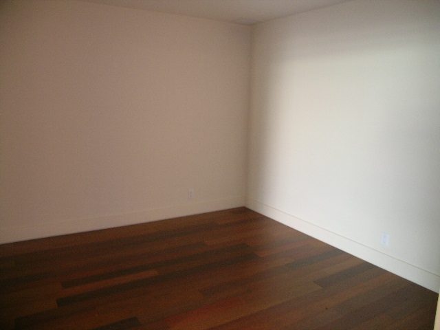 Den with hardwood floors and white walls. - 602 - 3355 Cypress Place, West Vancouver