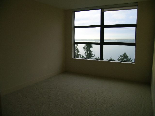 Spacious den with large windows offering a serene view of the water and trees. - 602 - 3355 Cypress Place, West Vancouver
