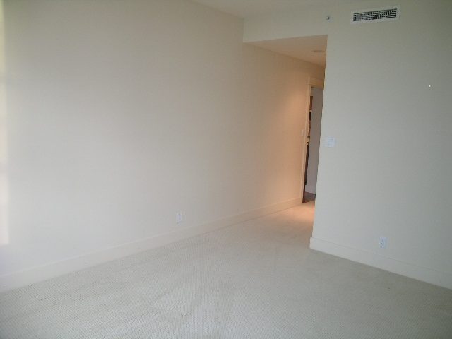 Bright living room with carpeted floor and neutral walls. - 602 - 3355 Cypress Place, West Vancouver