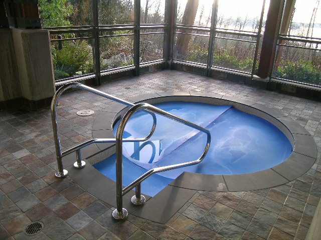 Spacious sunroom with a hot tub and scenic view. - 602 - 3355 Cypress Place, West Vancouver
