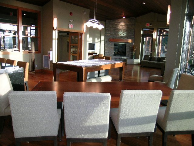 Furnished living room with hardwood floors, modern furniture, and a fireplace. - 602 - 3355 Cypress Place, West Vancouver
