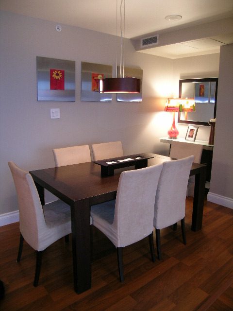 Furnished dining area with modern decor, hardwood floors, and a sleek table setup. - 508 - 1408 Strathmore Mews, Vancouver Downtown
