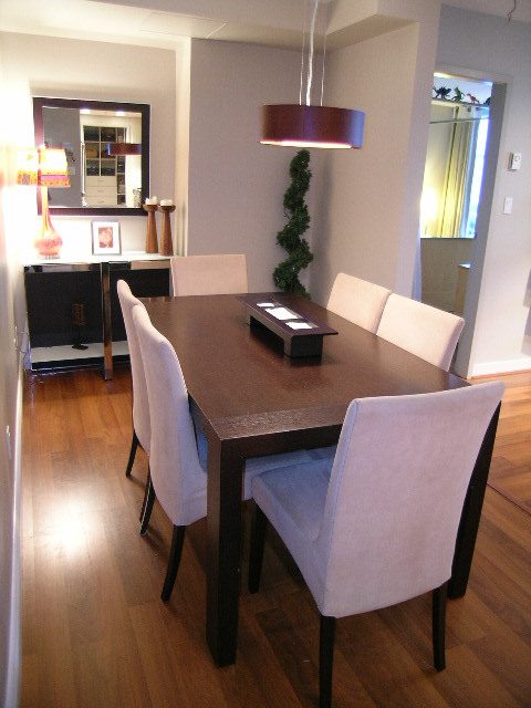 Furnished dining area with modern decor, hardwood floors, and a sleek table setup. - 508 - 1408 Strathmore Mews, Vancouver Downtown