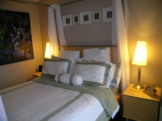 Furnished 2-bedroom condo with cozy canopy bed, soft lighting, and modern decor. - 508 - 1408 Strathmore Mews, Vancouver Downtown