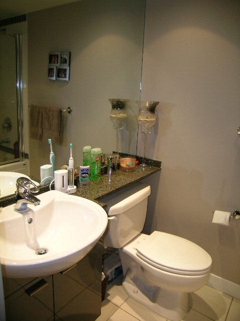 Bathroom with modern sink, countertop, and toilet. - 508 - 1408 Strathmore Mews, Vancouver Downtown