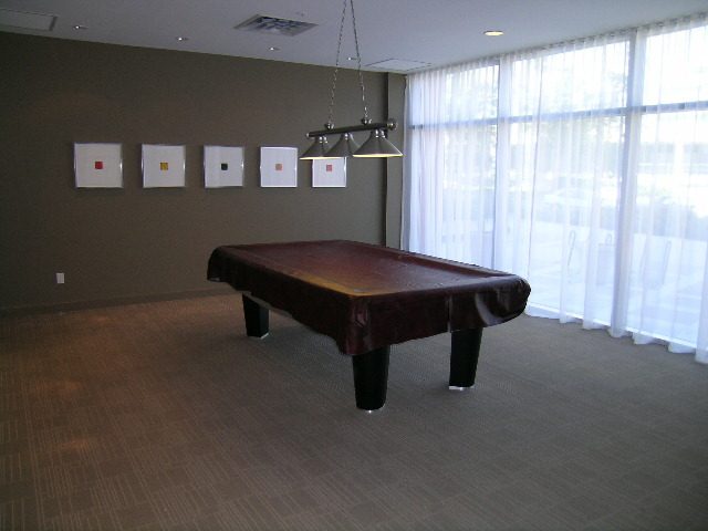 Living room with modern furniture, large windows, and artwork on the wall. - 508 - 1408 Strathmore Mews, Vancouver Downtown