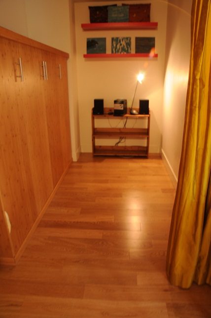 Cozy den with wooden floors, built-in shelves, and a desk setup. - 608 - 565 Smithe Street, Vancouver Downtown