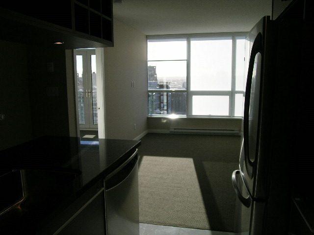 Spacious kitchen with modern countertops and city view. - 2307 - 833 Seymour Street, Vancouver Downtown