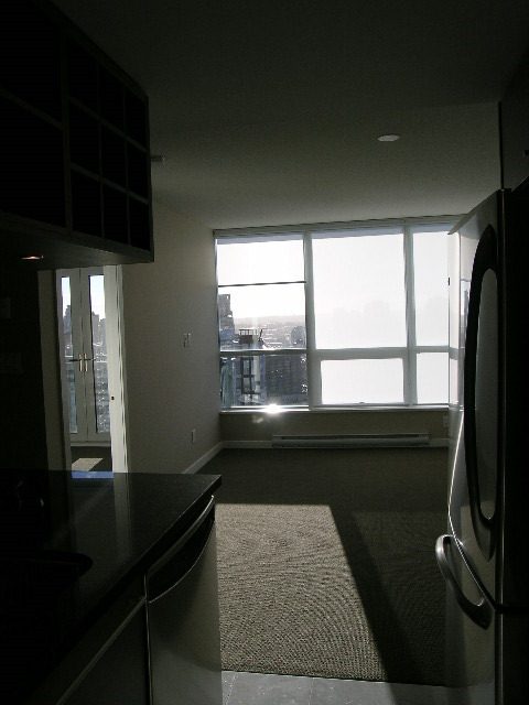 Spacious kitchen with sleek countertops and a city view. - 2307 - 833 Seymour Street, Vancouver Downtown