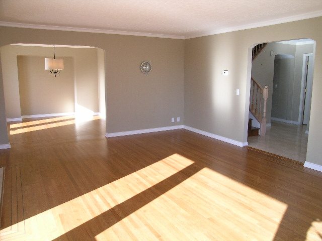 Spacious living room with hardwood floors and a view of the staircase. - 1875 26th Street, West Vancouver