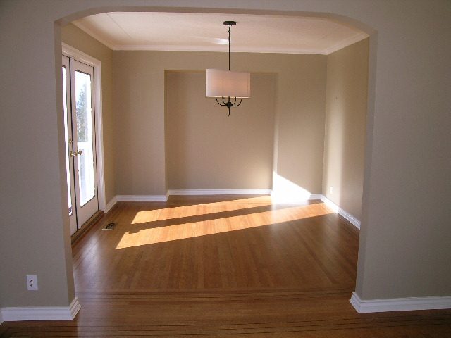 Bright dining area with hardwood floors and a modern chandelier. - 1875 26th Street, West Vancouver