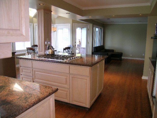 Bright kitchen with granite countertops, hardwood floors, and a view of the living area. - 1875 26th Street, West Vancouver