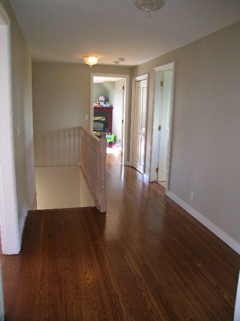 Spacious hallway with hardwood floors and a view of the living area ahead. - 1875 26th Street, West Vancouver