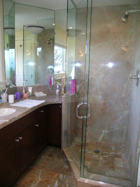 Modern bathroom with marble countertops and glass shower enclosure. - 1875 26th Street, West Vancouver