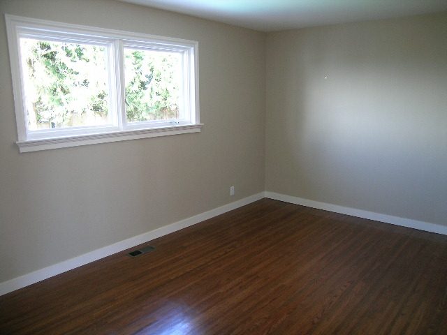 Spacious living room with hardwood floors and large windows. - 1875 26th Street, West Vancouver