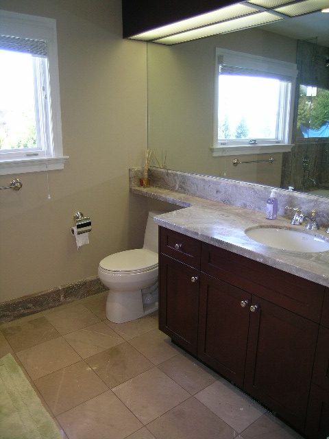 Spacious bathroom with granite countertops and a large vanity sink, featuring a window view. - 1875 26th Street, West Vancouver