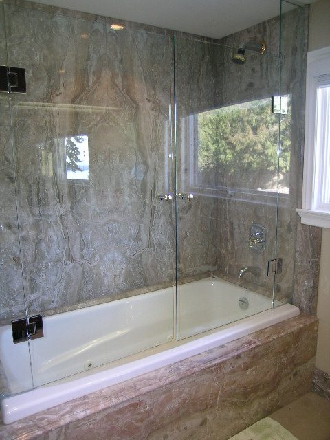 Spacious bathroom with marble walls and a large glass-enclosed shower. - 1875 26th Street, West Vancouver