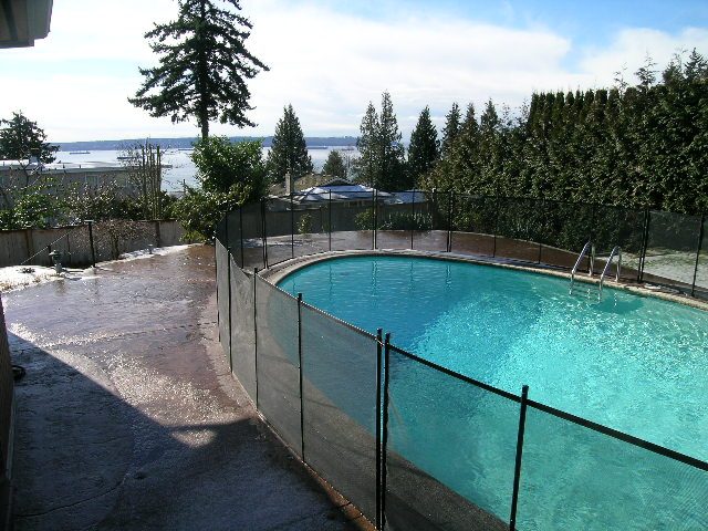 Spacious backyard with a stunning view of the ocean and lush greenery, perfect for relaxation. - 1875 26th Street, West Vancouver