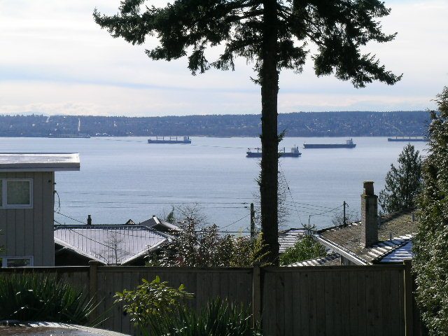 Oceanfront living room with stunning city view and waterfront access. - 1875 26th Street, West Vancouver