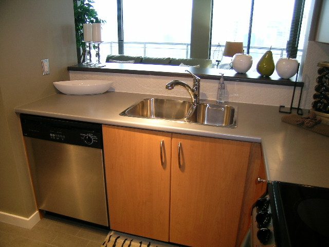 Bright kitchen with stainless steel sink, granite countertops, and city view. - 2109 - 1295 Richards Street, Vancouver Downtown