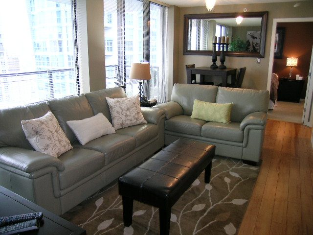 Spacious living room with city view, modern furnishings, and hardwood floors. - 2109 - 1295 Richards Street, Vancouver Downtown