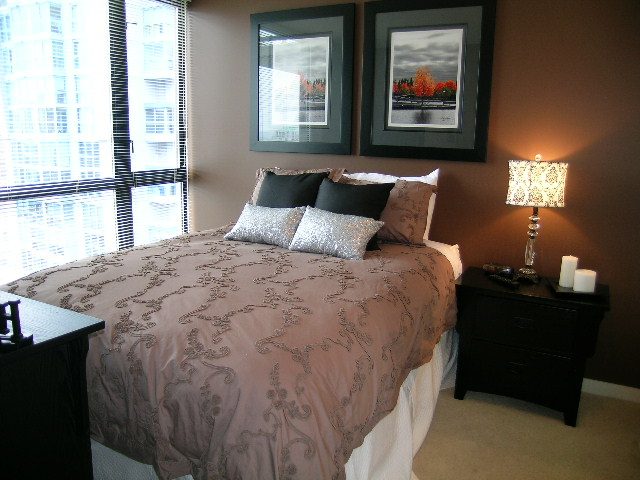 Spacious 2-bedroom condo with a cozy bedroom featuring a large bed, city view, and elegant decor. - 2109 - 1295 Richards Street, Vancouver Downtown