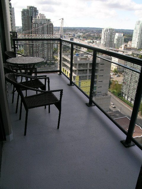 Spacious balcony with city view, furnished seating, and modern cityscape backdrop. - 2109 - 1295 Richards Street, Vancouver Downtown
