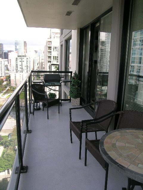Spacious balcony with city view, furnished seating, and modern decor. - 2109 - 1295 Richards Street, Vancouver Downtown