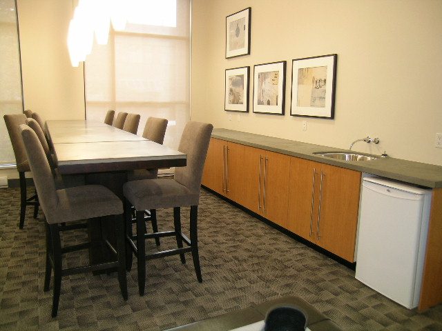 Modern kitchen with granite countertops and stainless steel appliances, perfect for a cozy downtown condo.