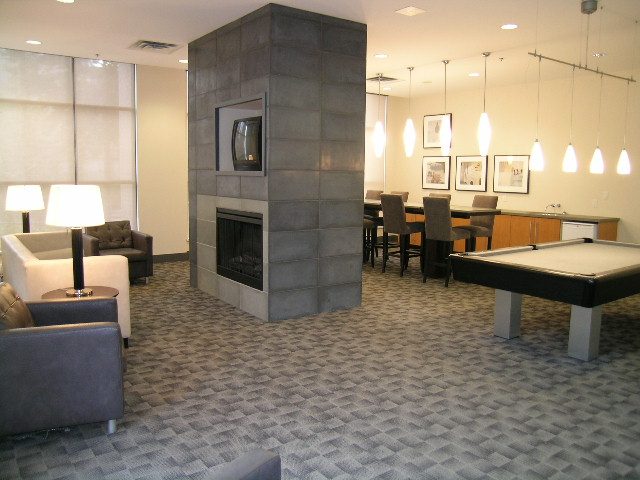 Spacious living room with modern fireplace, sleek countertops, and stylish pendant lights. - 2109 - 1295 Richards Street, Vancouver Downtown