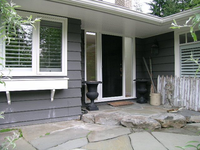 Cozy front porch with stone steps and decorative urns, perfect for relaxation. - 2795 Palmerston Avenue, West Vancouver