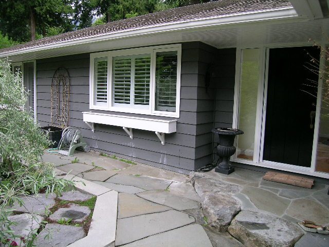 Spacious patio with stone pathway and modern shutters, perfect for relaxation. - 2795 Palmerston Avenue, West Vancouver