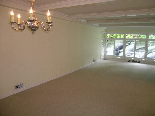 Spacious living room with elegant chandelier and large windows. - 2795 Palmerston Avenue, West Vancouver