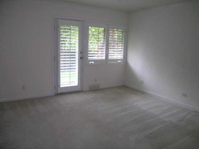 Spacious bedroom with white walls, large windows, and hardwood floors. - 2795 Palmerston Avenue, West Vancouver