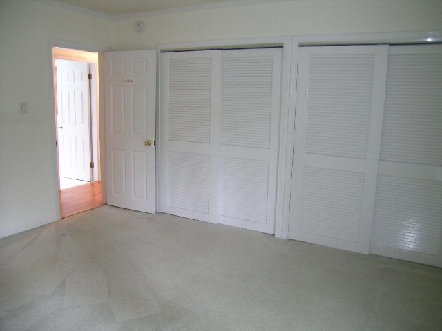 Spacious bedroom with sliding closet doors and carpeted floor. - 2795 Palmerston Avenue, West Vancouver