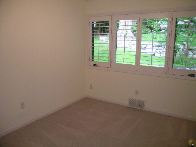 Spacious bedroom with large windows and a view of greenery. - 2795 Palmerston Avenue, West Vancouver