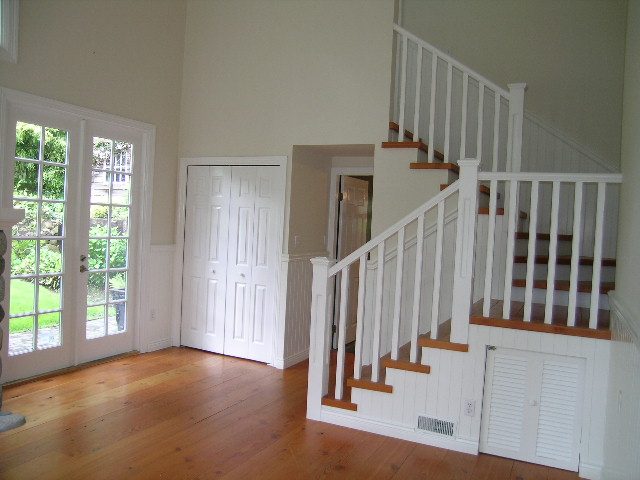 Spacious living room with hardwood floors, French doors, and white staircase leading to upper level. - 2795 Palmerston Avenue, West Vancouver