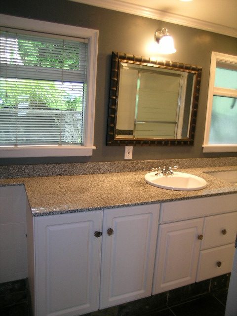 Bathroom with granite countertops and a large mirror, featuring a window with blinds. - 2795 Palmerston Avenue, West Vancouver