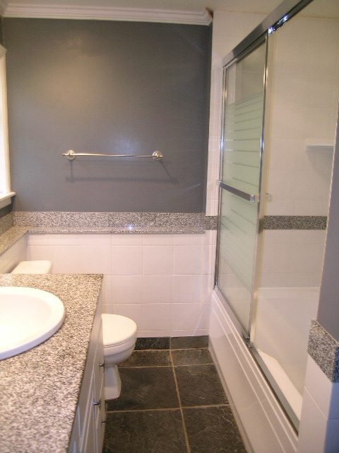Modern bathroom with granite countertops and a glass shower door. - 2795 Palmerston Avenue, West Vancouver