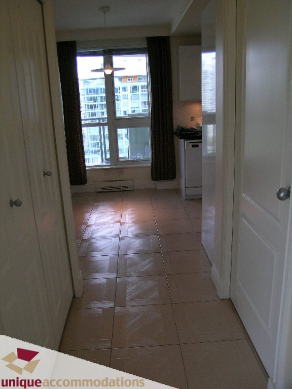 Bright kitchen with tiled floor, city view, and modern appliances. - 1903 - 535 Nicola Street, Vancouver Downtown