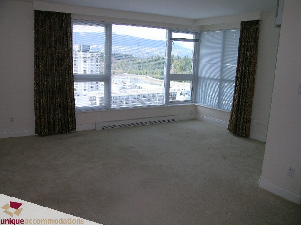 Spacious living room with large windows offering a stunning city view and carpeted floors. - 1903 - 535 Nicola Street, Vancouver Downtown