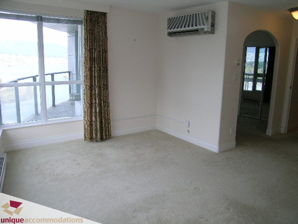 Spacious living room with large windows, city view, and carpeted floor. - 1903 - 535 Nicola Street, Vancouver Downtown