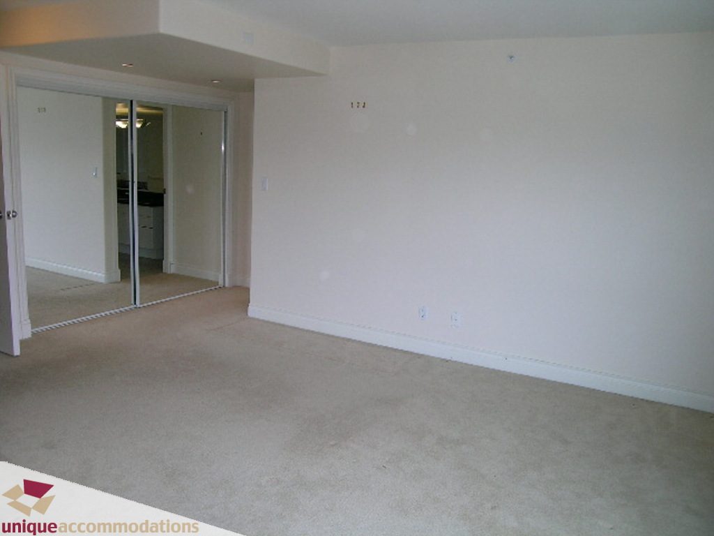Spacious living room with beige carpet and sliding glass doors leading to a balcony. - 1903 - 535 Nicola Street, Vancouver Downtown
