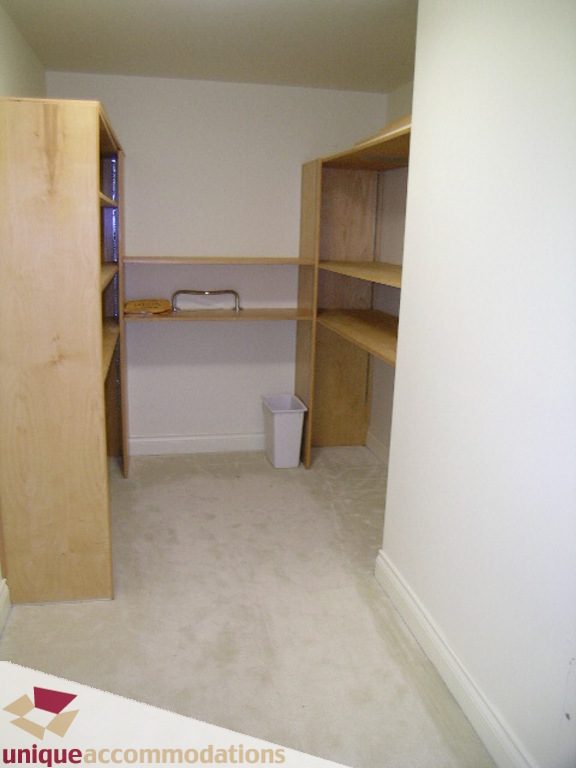 Compact bedroom with built-in shelving and a small desk, perfect for a cozy stay. - 1903 - 535 Nicola Street, Vancouver Downtown