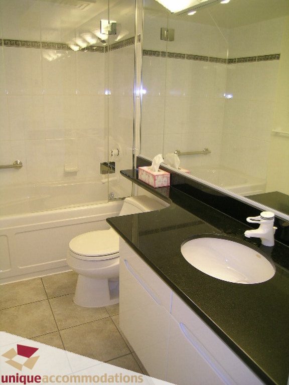 Bathroom with black granite countertop, modern sink, and walk-in shower. - 1903 - 535 Nicola Street, Vancouver Downtown