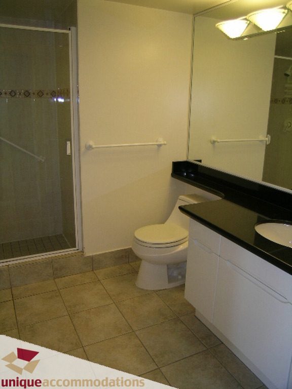 Bathroom with black countertops, white fixtures, and grab bars for accessibility. - 1903 - 535 Nicola Street, Vancouver Downtown