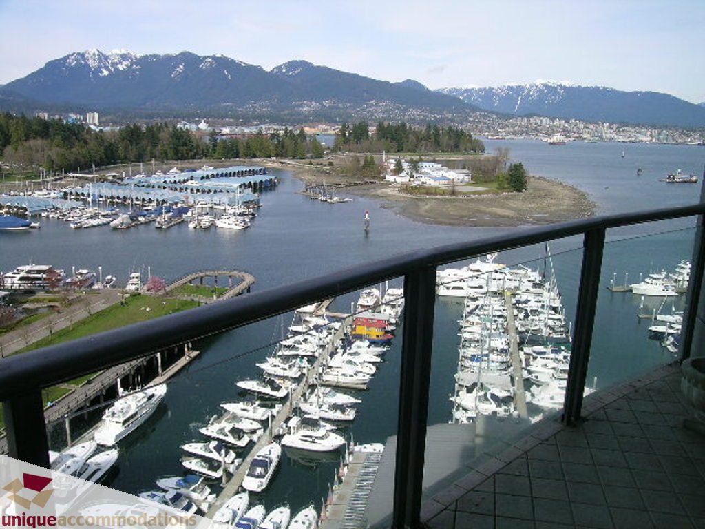 Spacious balcony with stunning city and marina views, featuring a black railing and tiled floor. - 1903 - 535 Nicola Street, Vancouver Downtown